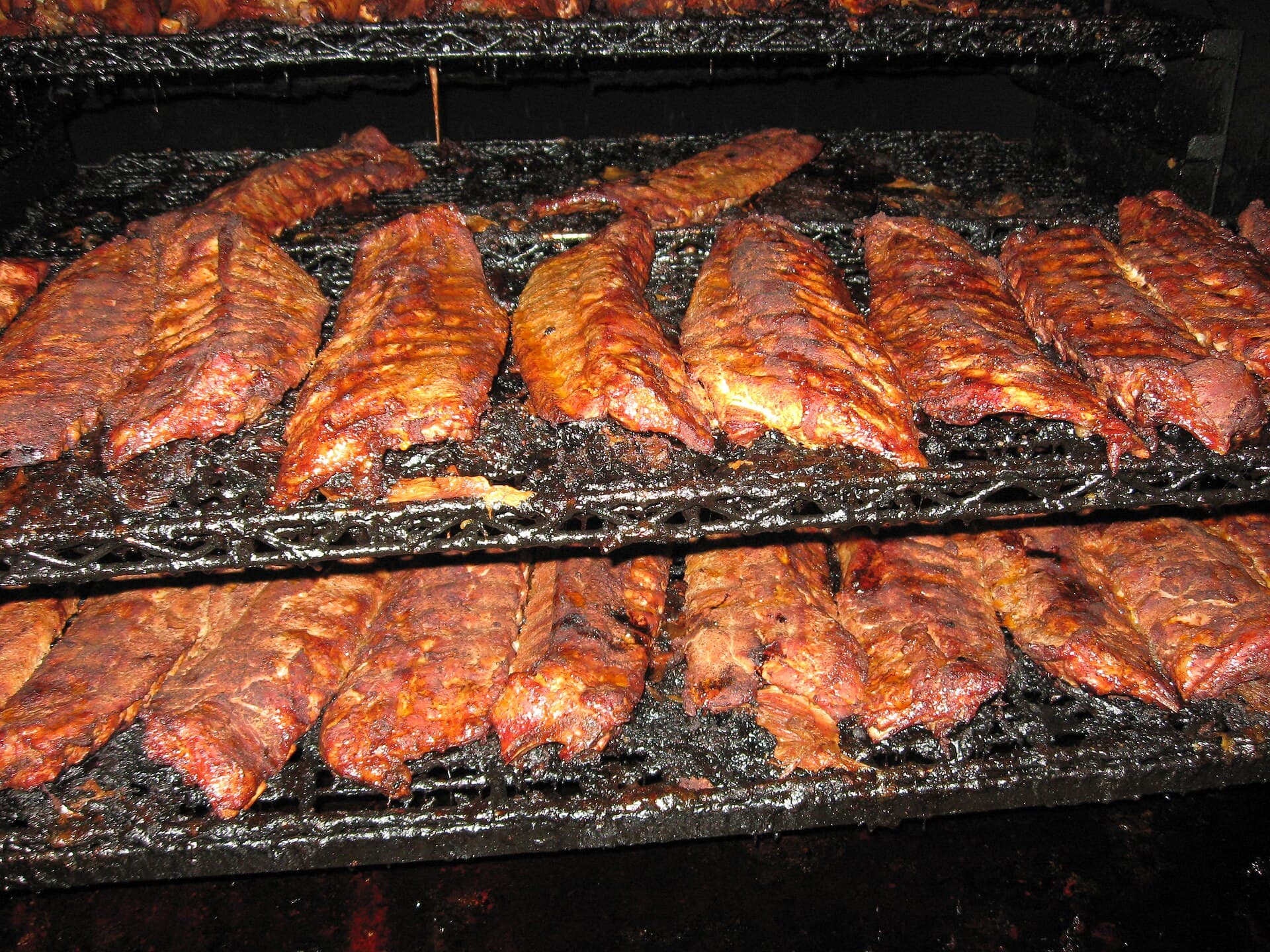 Racks of pork ribs smoking in the pit at Central BBQ in Memphis