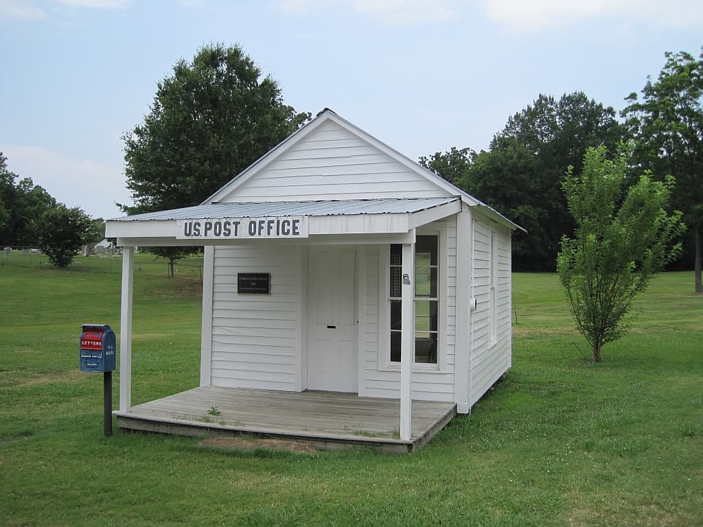 The restored Old Cordova Post Office, a small white clapboard building with a U.S. Post Office sign, in Cordova, Tennessee