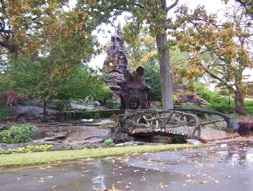The Crystal Shrine Grotto entrance at Memorial Park Cemetery, with Dionicio Rodríguez's faux bois tree sculpture and root bridge