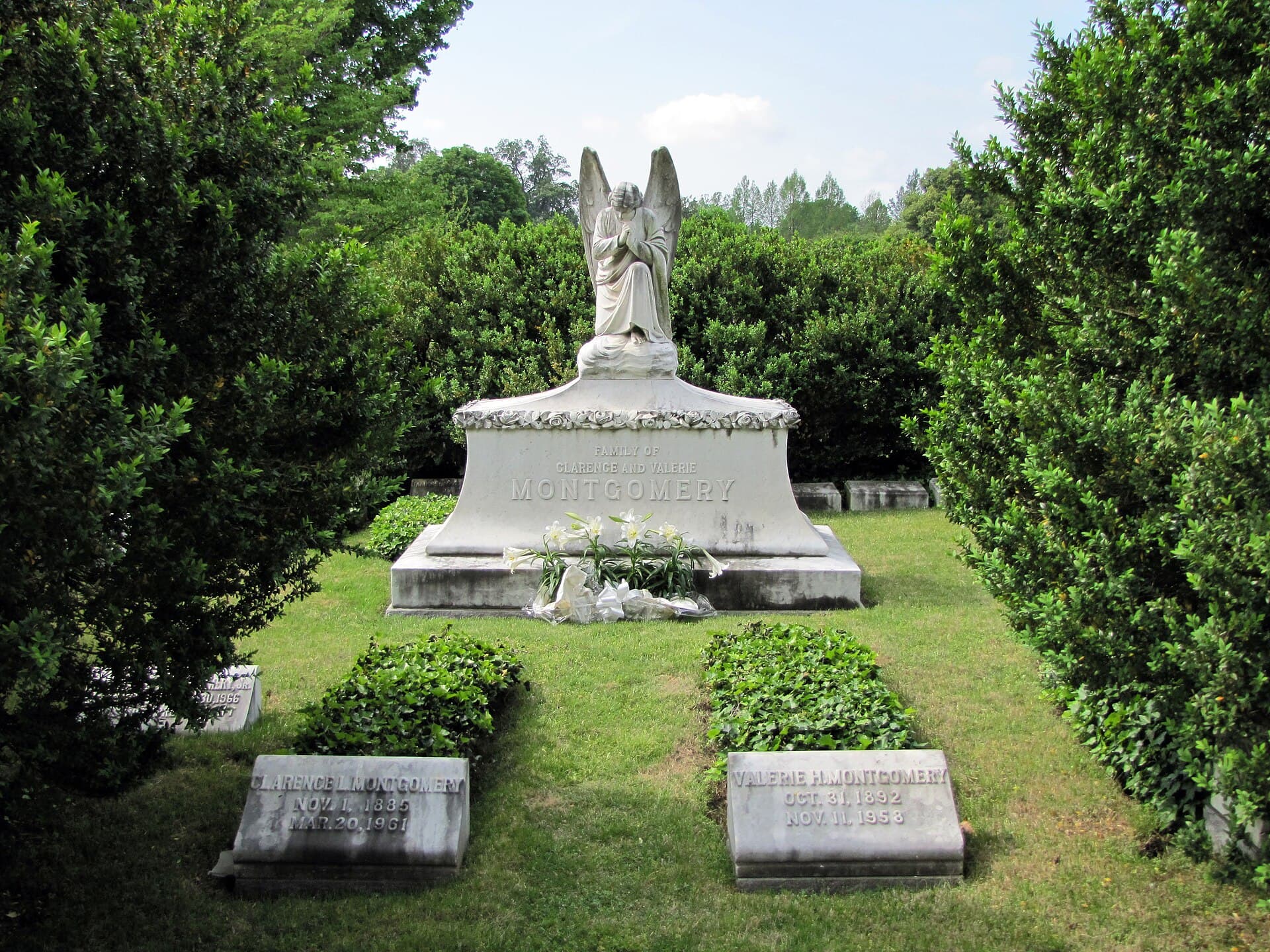 A kneeling stone angel over a family monument at Elmwood Cemetery in Memphis