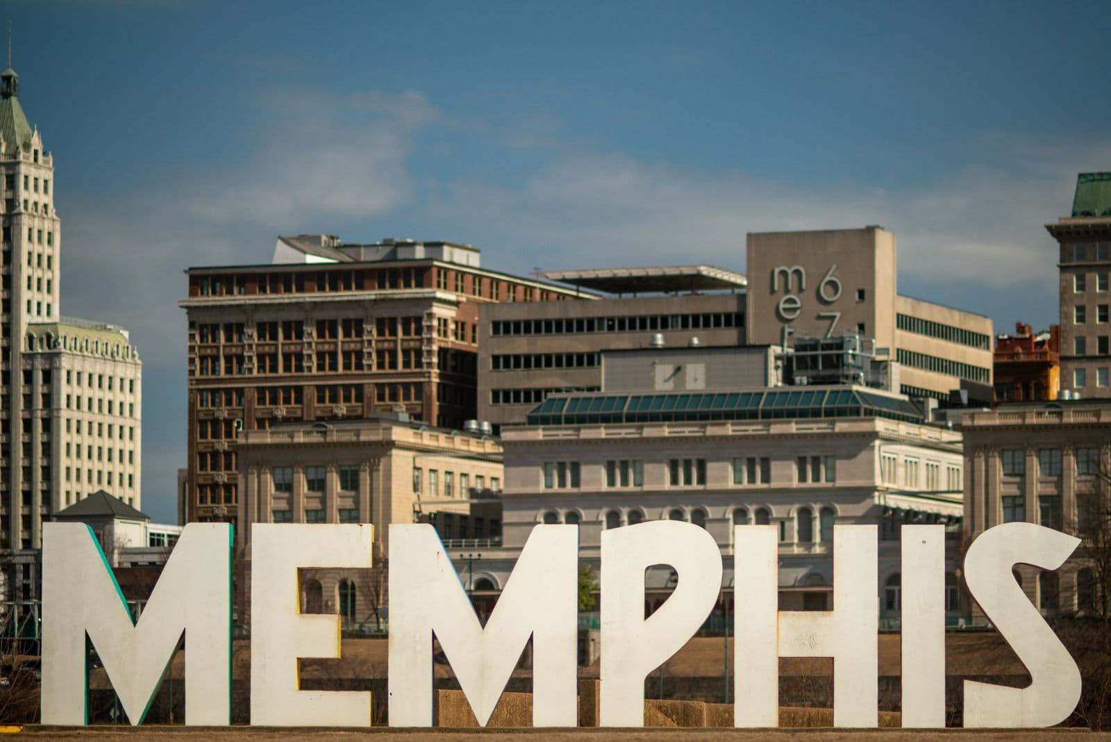 The MEMPHIS letters on the riverfront with the downtown skyline behind them