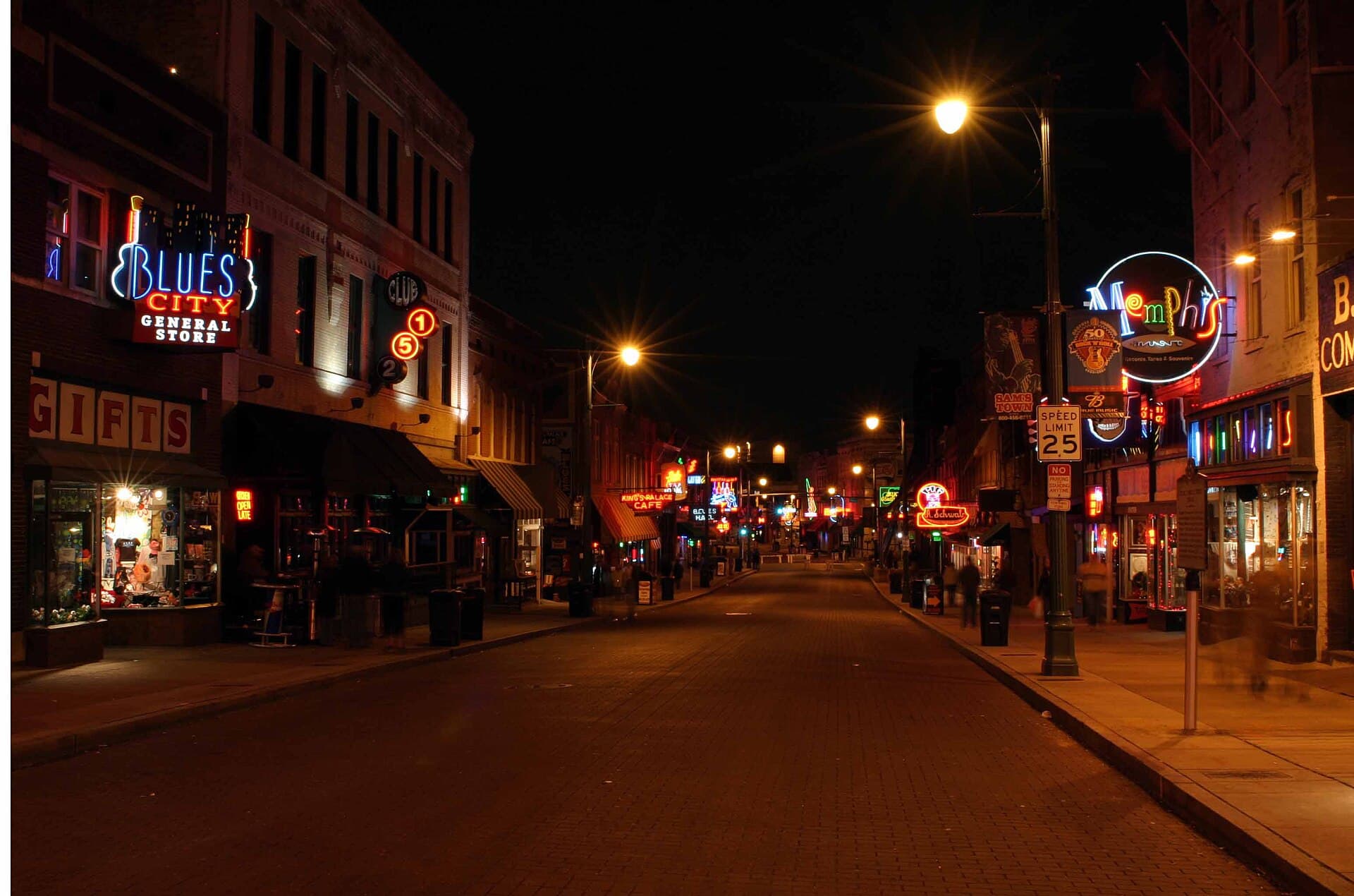 Beale Street in downtown Memphis late at night, neon signs lit outside Blues City and King's Palace Cafe